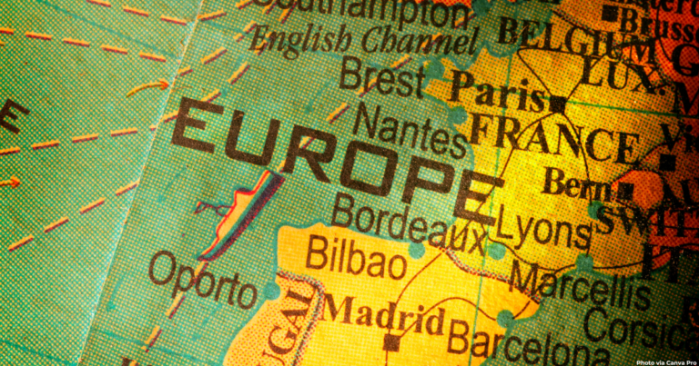 Close-up of a vintage globe showing Western Europe map with "EUROPE" prominently displayed across the continent. Key cities for backpacking Europe itinerary visible include Paris, Madrid, Barcelona, and Bordeaux, with France highlighted in yellow against the teal-colored Atlantic Ocean. Perfect for planning a 1 month backpacking Europe itinerary across multiple countries.